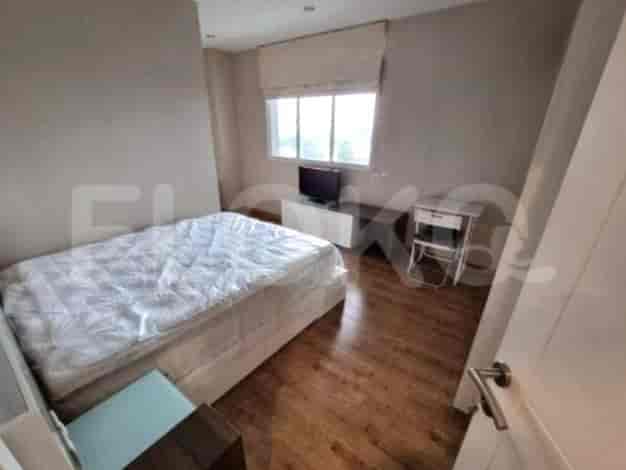 A bedroom with a bed and TV.