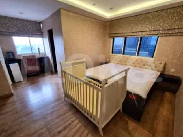 A bedroom with a bed and a crib.