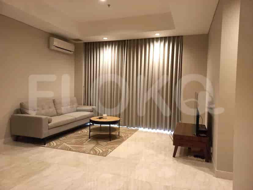 Modern living room with sofa, coffee table, and TV.