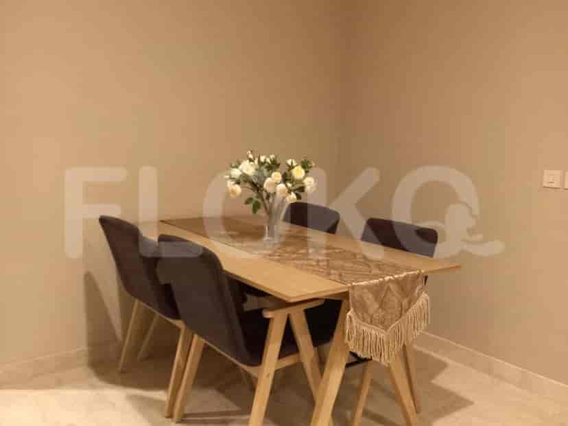 Dining area with table, chairs, and a floral centerpiece.