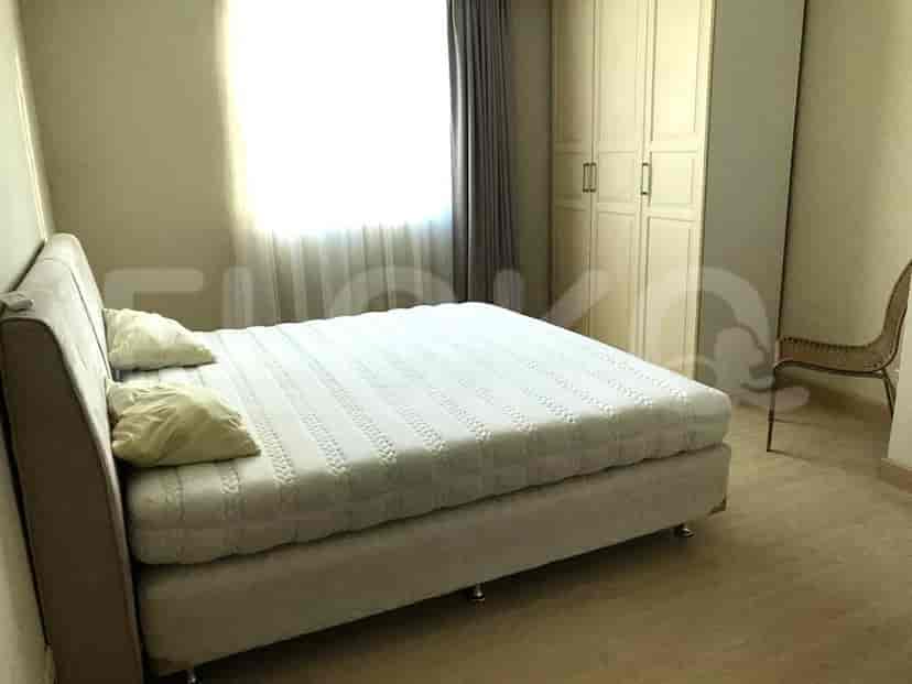 Bedroom with a large bed, wardrobe, and chair.