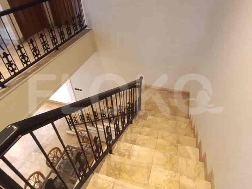 Staircase with marble steps and a black metal railing.