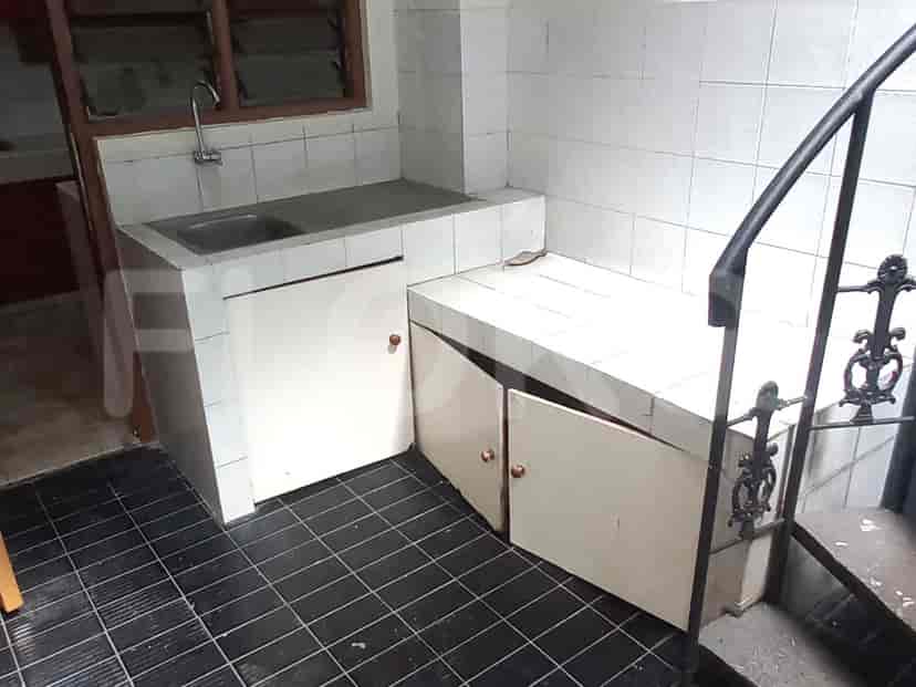 A kitchen with white cabinetry and a small sink area.