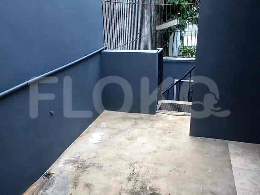 Exterior view with grey walls and pipes.