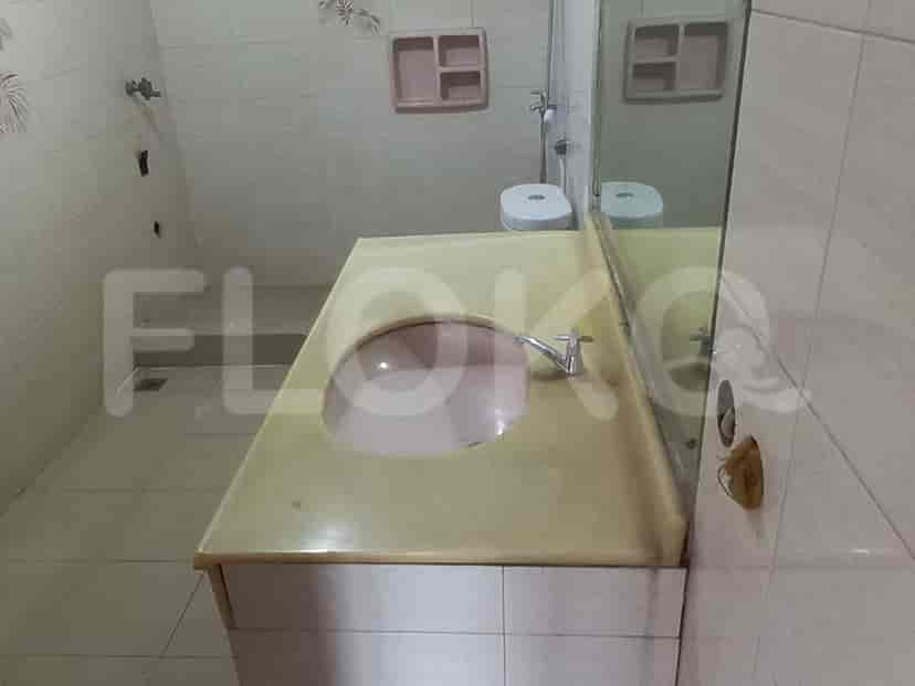 A bathroom with a sink, mirror, and a toilet.