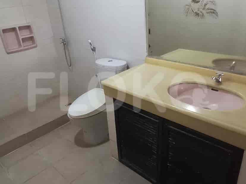 A bathroom with a sink, mirror, and a toilet.