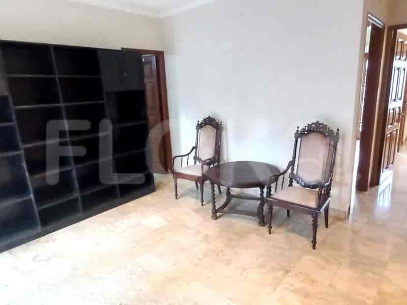 A hallway on the second floor with chairs and a small table.
