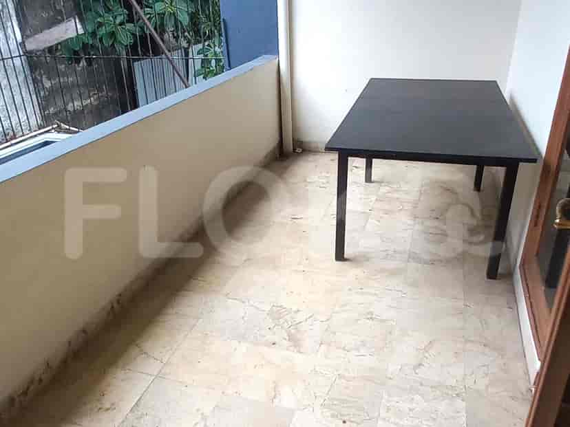 Balcony with a black table and chairs.