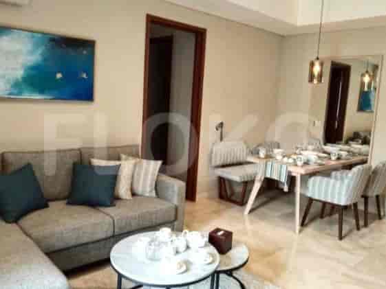 Living room with a sofa, dining area, and decorative elements.