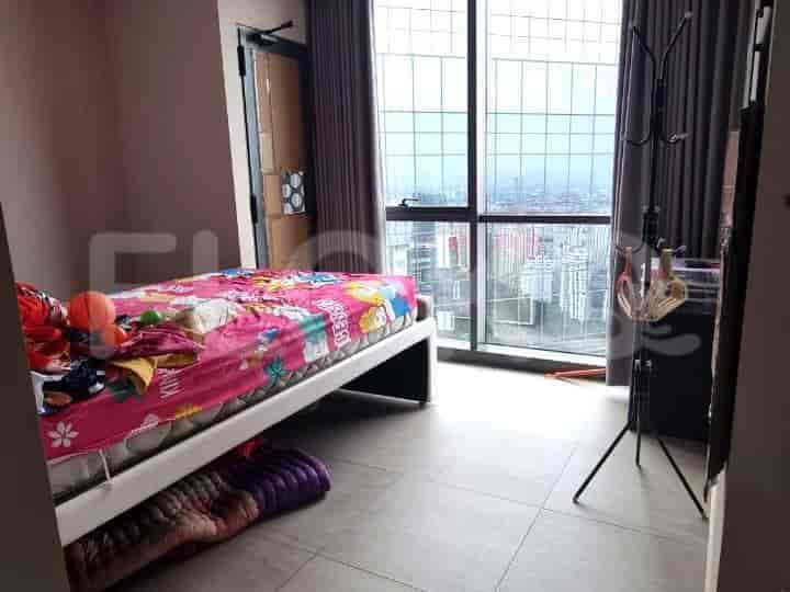 A bedroom with a bed, curtains, and a city view.