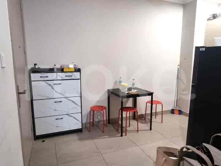 A compact kitchen and dining area with stools and storage.