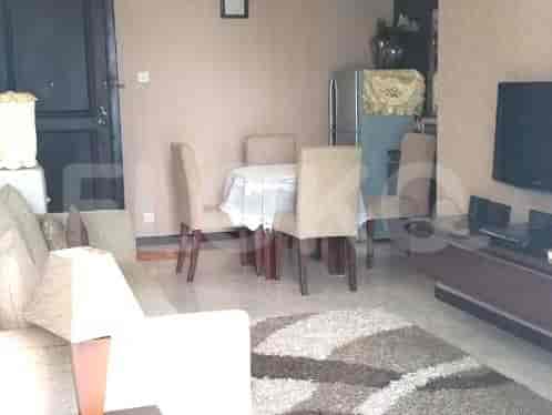 Combined living and dining space with a dining table and chairs, a sofa, and a cabinet with a TV.
