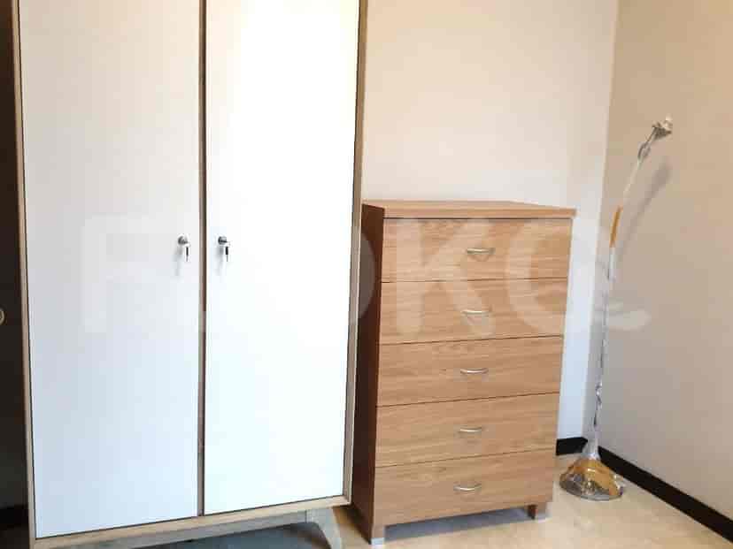 A room with a wardrobe and chest of drawers.