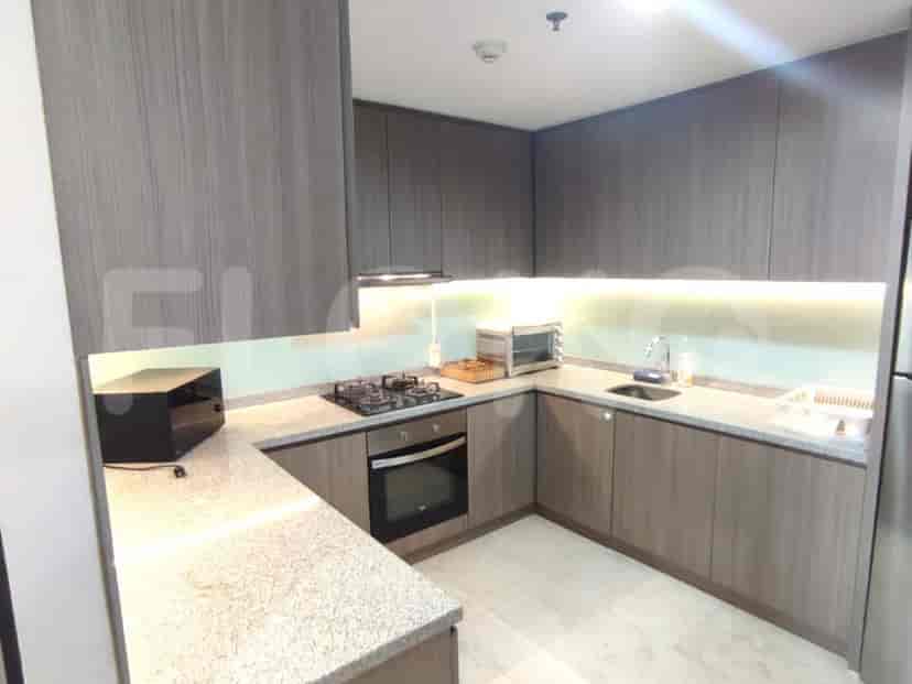 A well-equipped kitchen with wooden cabinetry, a stainless steel sink, and modern appliances.