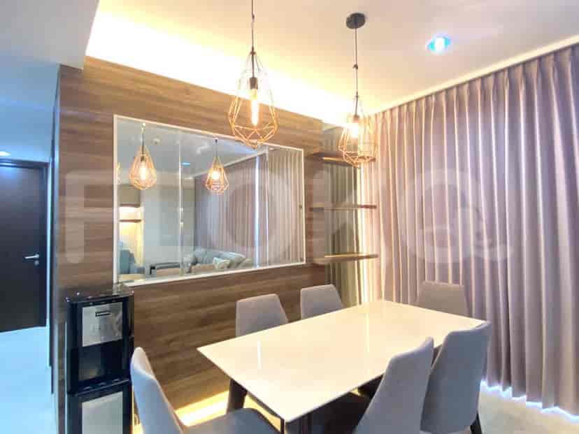 Combined living and dining area with a dining table, chairs, and pendant lights.