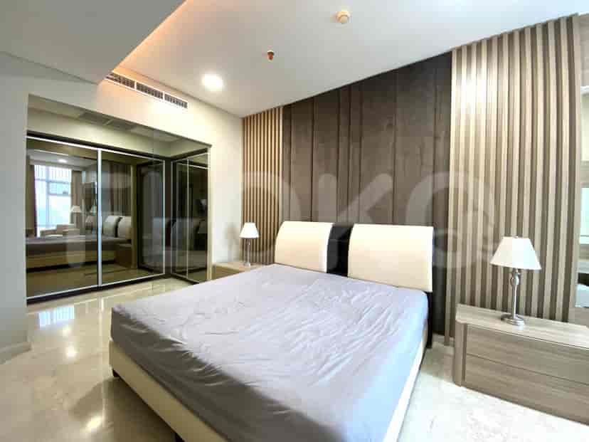 Master bedroom with a bed, side tables and a closet.
