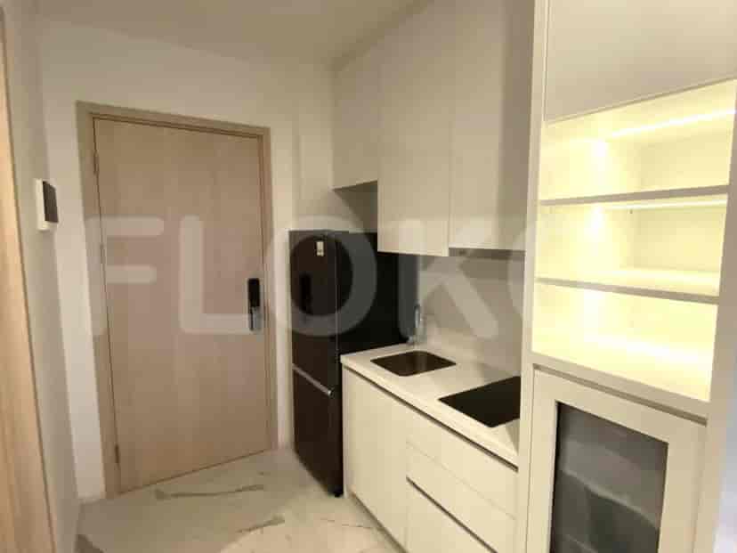 Modern kitchen with white cabinetry and essential appliances.