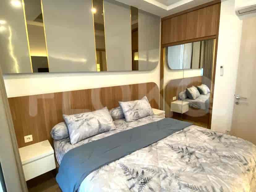 Comfortable bedroom with elegant decor and large mirror.