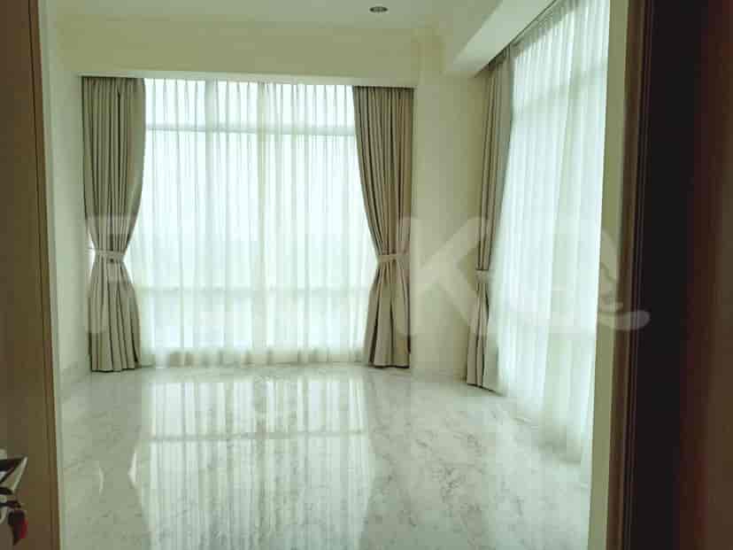 Living room with large window and sheer curtains.