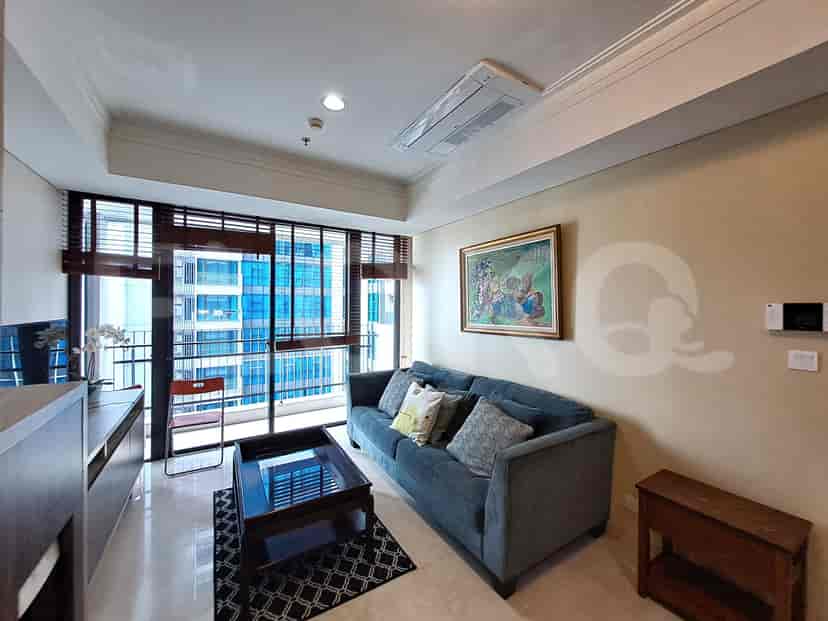 Another view of the living room, showcasing the city view and furniture arrangement.