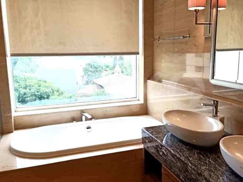 A luxurious bathroom with a large bathtub and vessel sinks.