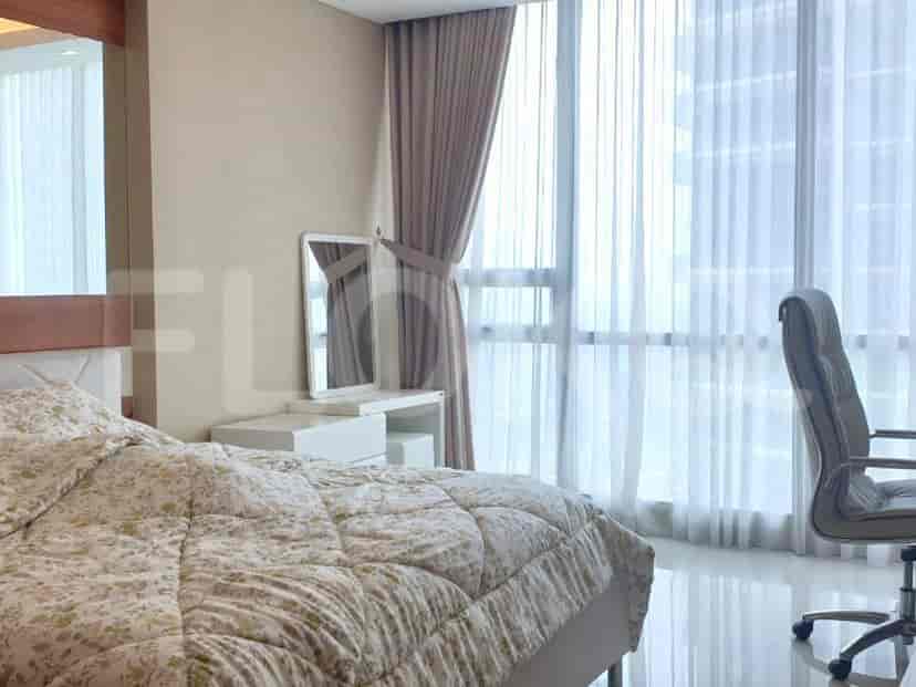 Bedroom with a bed, mirror, and desk.