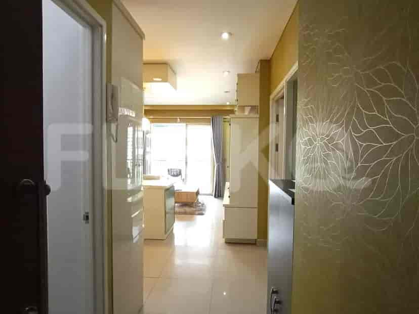 The hallway leading to the main living area, kitchen and bedrooms.