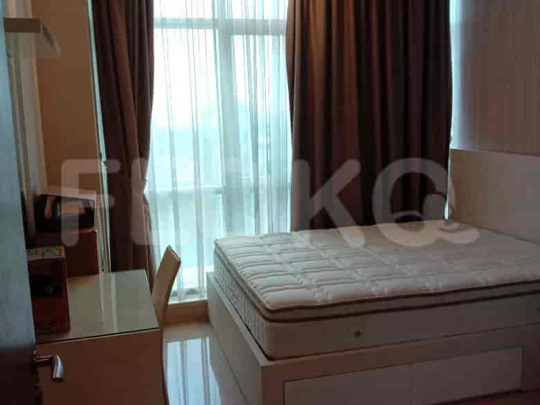 Bedroom with a bed, desk and windows.