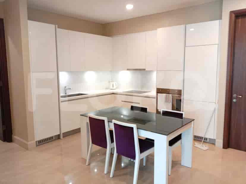 Modern kitchen with white cabinets and a dining area with a table and chairs.