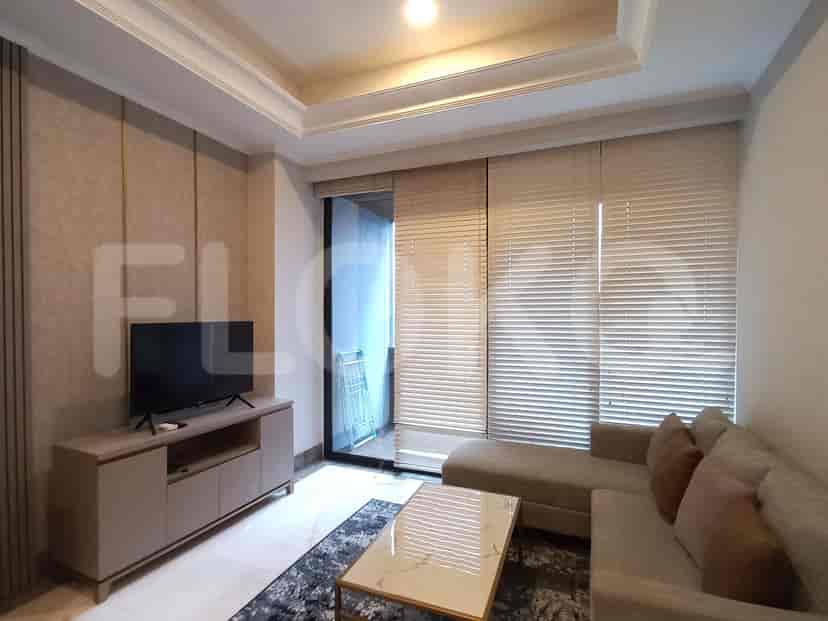 Modern living room featuring a sectional sofa, TV unit, and access to a balcony with blinds.