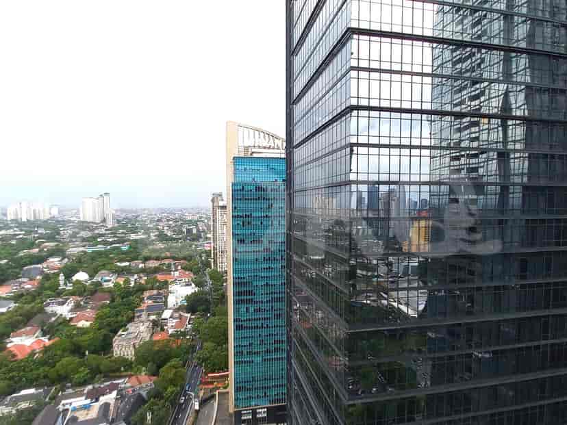 City view from the apartment, showcasing skyscrapers and surrounding buildings.