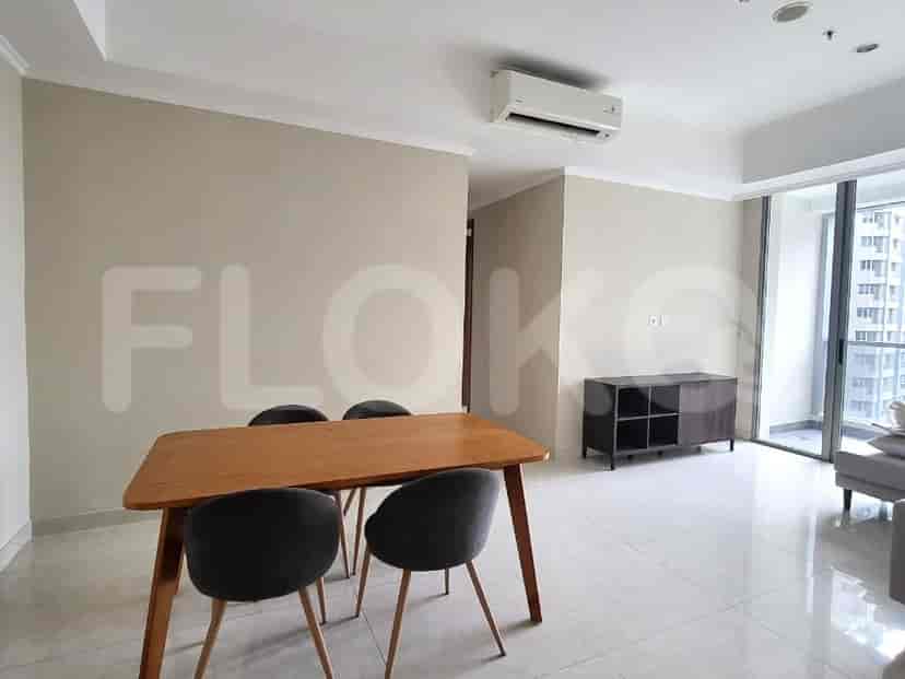 The dining area with a wooden table and dark chairs.