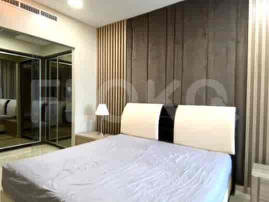 A bedroom with a large bed and mirrored closet.