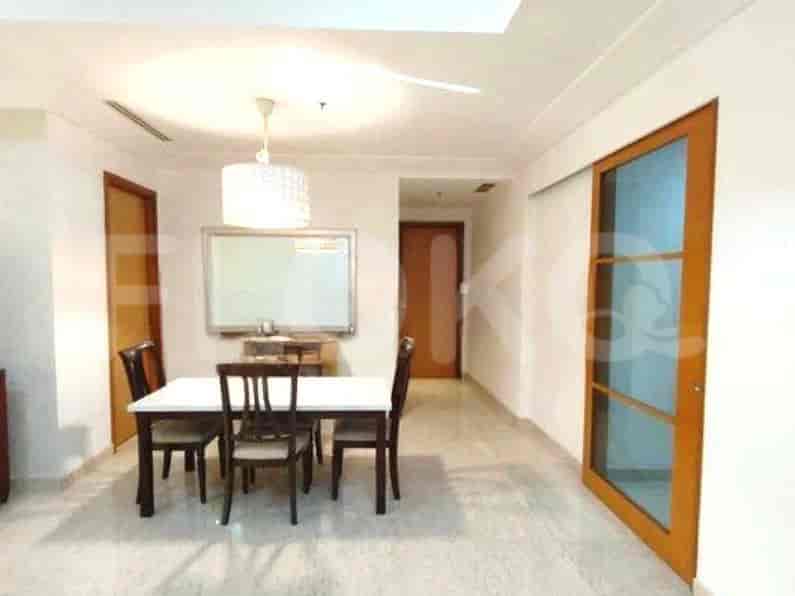 Dining area with a table, chairs, and a sliding door.