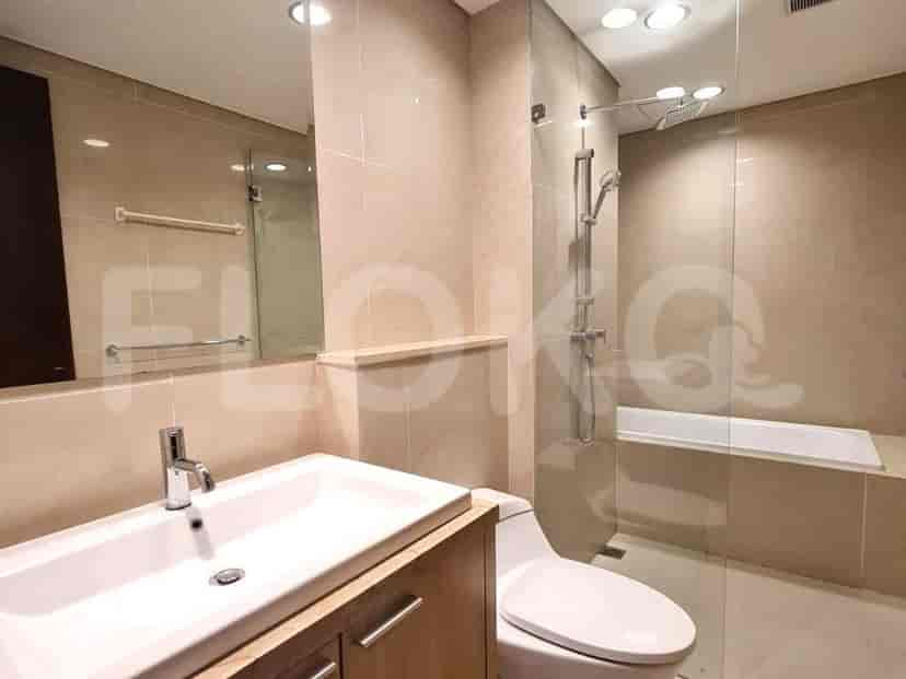 Modern bathroom with glass-enclosed shower and bathtub.