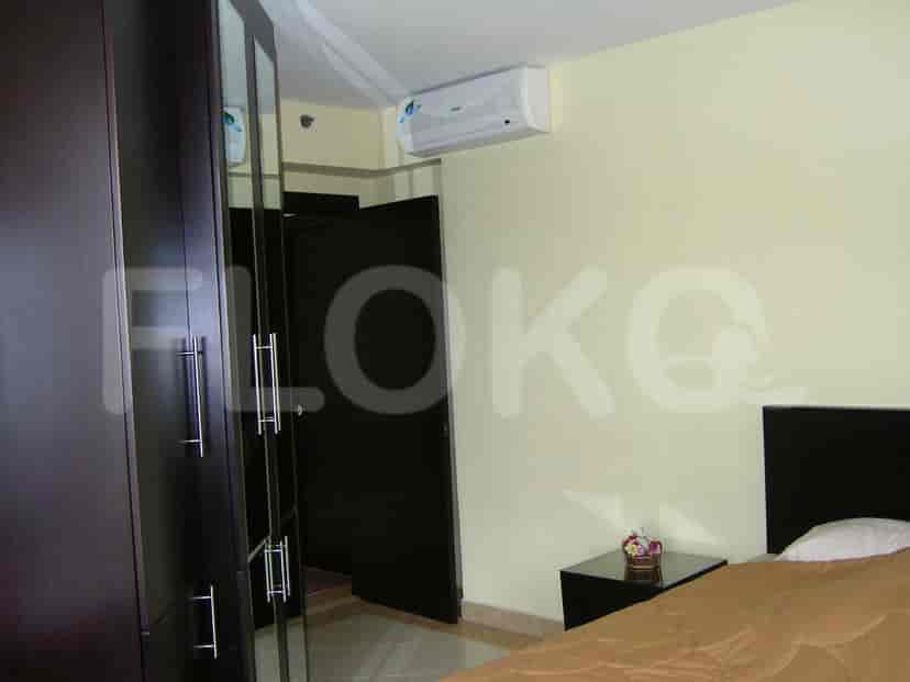 An additional view of the bedroom displaying the bed, air conditioning, and wardrobe.