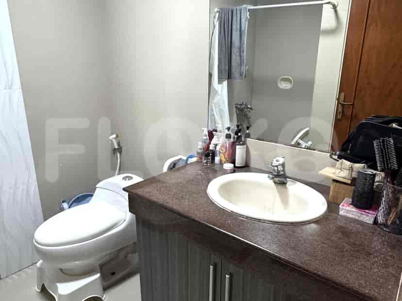 Bathroom with a sink, toilet, and a mirror.