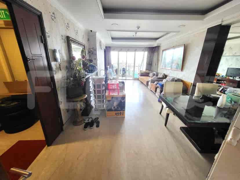 The combined living and dining space shows a sofa, a dining table, and an open balcony.