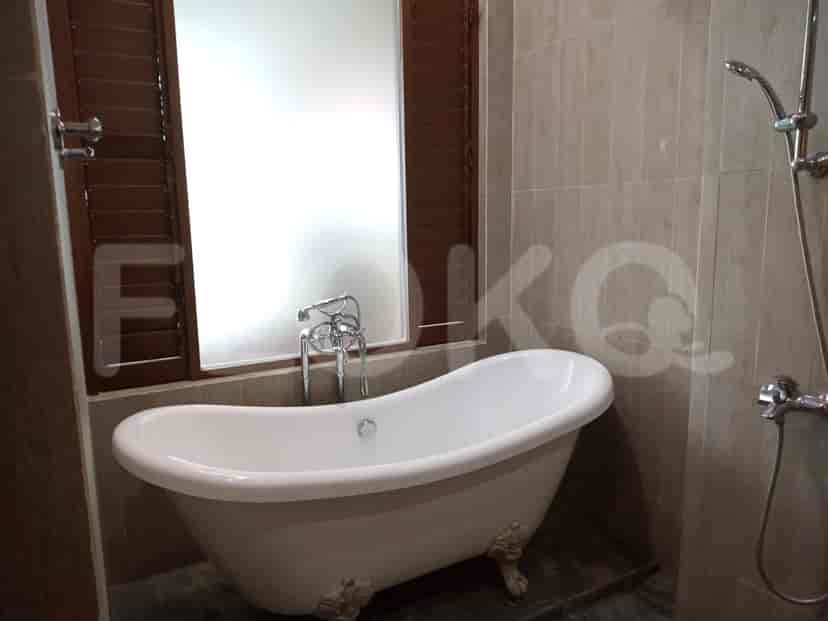 A bathroom featuring a bathtub, a window, and a showerhead.