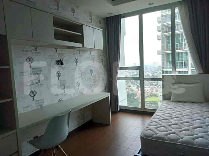 Bedroom with a desk, a bed, and built-in storage.