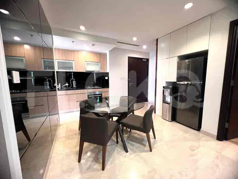Modern kitchen with wooden cabinets and a glass cooktop.