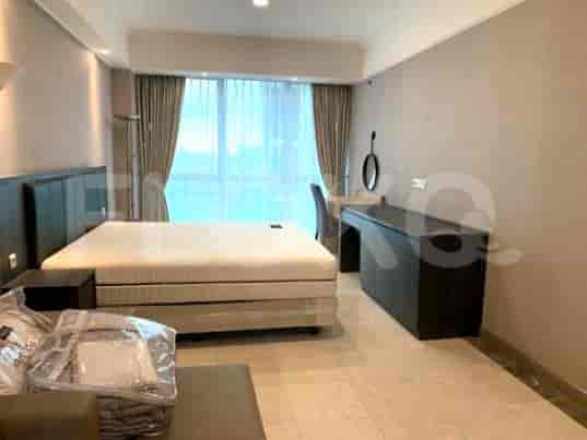 Bedroom with a double bed, a desk, and a large window.