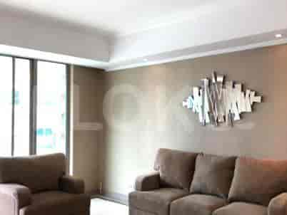 Living area with two sofas and a modern wall decoration.
