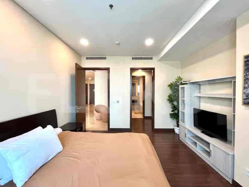 A bedroom with access to an ensuite bathroom and a hallway.