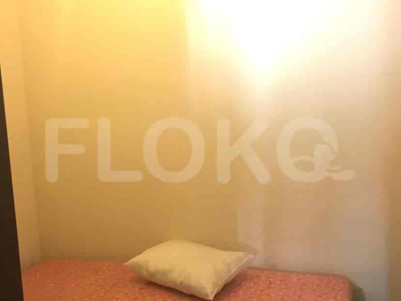 A small room with a bed and pillow.