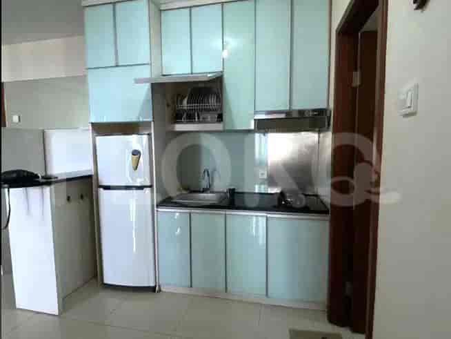 Modern kitchen with light blue cabinets and stainless steel appliances.