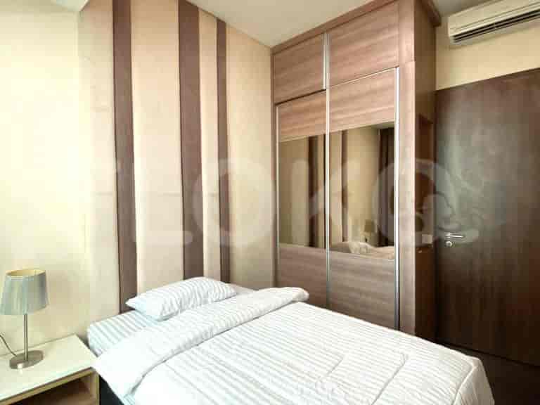 A bedroom with a bed and a built-in closet.