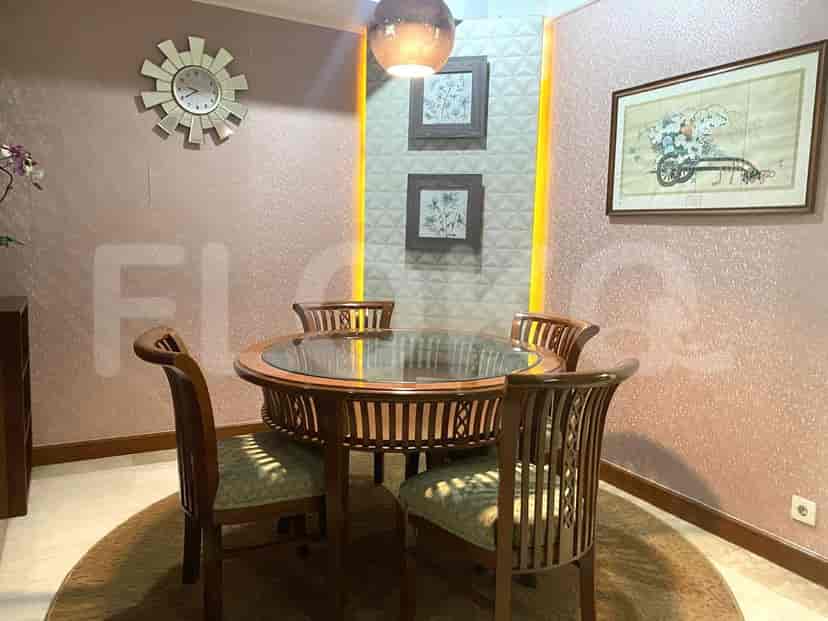 Dining area with a round wooden table and four chairs.