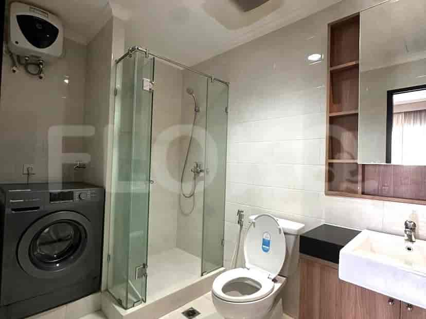 Bathroom featuring a shower, toilet, and washing machine.