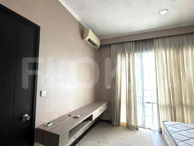 Bedroom with a TV cabinet, air conditioner, and a window.